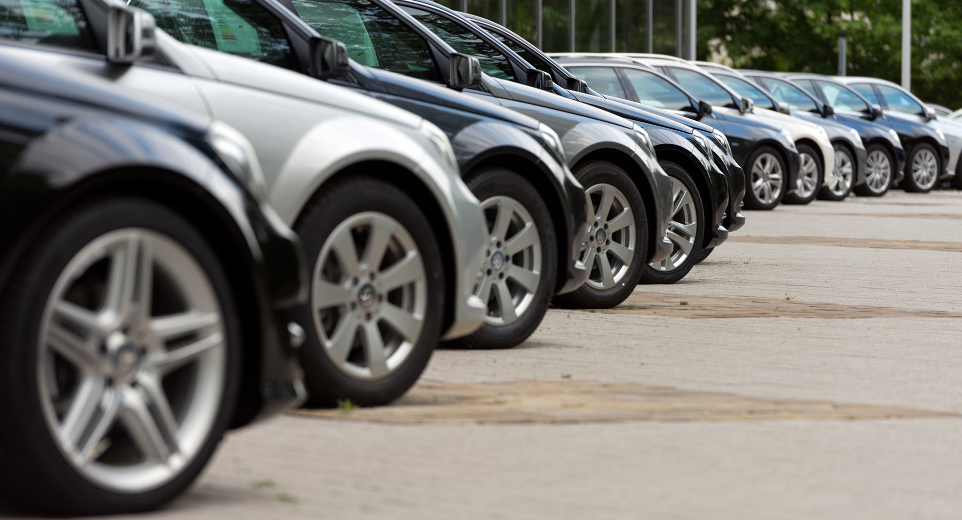 Lineup of vehicles parked in a dealership inventory lot